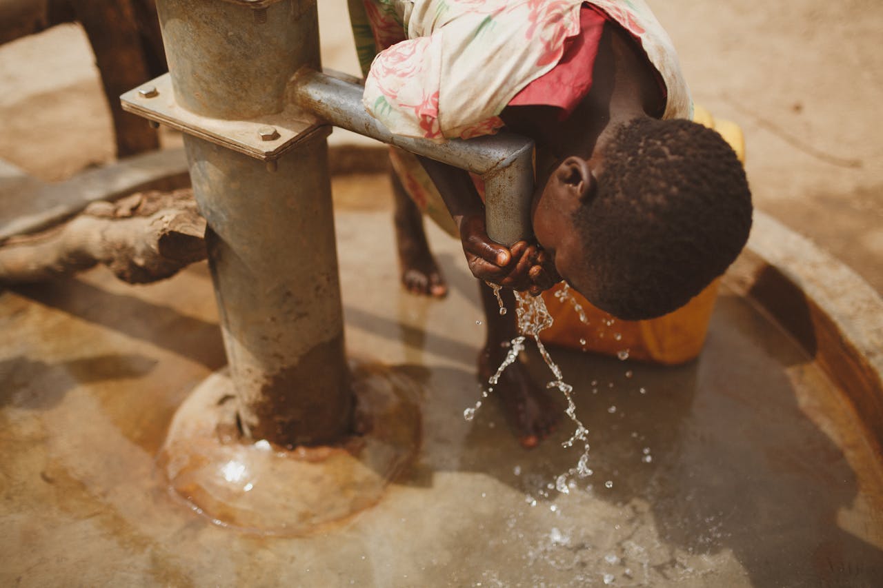 gallery-2 A girl bends to drink clean water from a well in Kitgum, Northern Uganda.